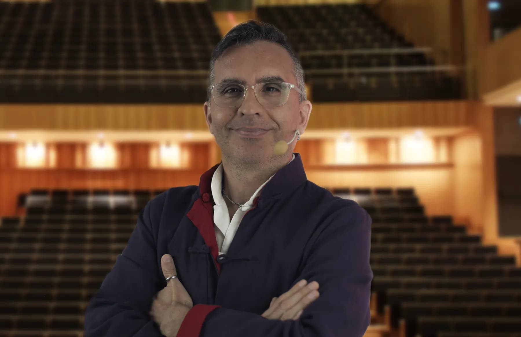 Retrato profesional de Diego Minevitz en un auditorio.